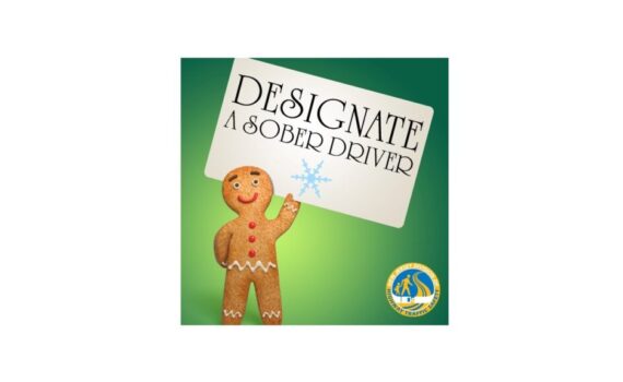 Gingerbread man holding designated driver sign.